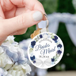 Bridesmaid Blue Watercolor Floral Wreath Wedding Keychain<br><div class="desc">These keychains are designed to give as favours to bridesmaids in your wedding party. They feature a rustic hand painted watercolor design with a wreath of roses and flowers in shades of dusty blue, navy and indigo. The text is written in elegant script letters, and there is room for her...</div>