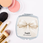 Bridesmaid bow beige cream elegant compact mirror<br><div class="desc">A beige,  cream coloured background. Decorated with a large bow.  Personalize and add your bridesmaid's name.   Black handwritten style script.</div>