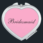 Bridesmaid Compact Mirror<br><div class="desc">Compact mirror shown in a heart shape with a pink background colour with Bridesmaid text in black. 
Customize this item or buy as is.</div>