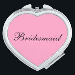 Bridesmaid Compact Mirror<br><div class="desc">Compact mirror shown in a heart shape with a pink background colour with Bridesmaid text in black.
Customize this item or buy as is.</div>