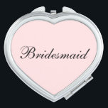 Bridesmaid Compact Mirror<br><div class="desc">Compact mirror shown in a heart shape with a blush pink background colour with Bridesmaid text in black. 
Customize this item or buy as is.</div>