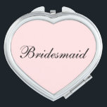 Bridesmaid Compact Mirror<br><div class="desc">Compact mirror shown in a heart shape with a blush pink background colour with Bridesmaid text in black.
Customize this item or buy as is.</div>