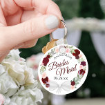 Bridesmaid Elegant Red Floral Wreath Wedding Keychain<br><div class="desc">These keychains are designed to give as favours to bridesmaids in your wedding party. They feature a rustic hand painted watercolor design with a wreath of roses and flowers in shades of red, burgundy, and blush pink. The text is written in elegant script letters, and there is room for her...</div>