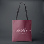 Bridesmaid Gift Burgundy Personalized Tote Bag<br><div class="desc">This Bridesmaid accessory bag features a handwritten white script typography with swashes on a burgundy background. Present your bridesmaids with a tote bag for small items traditionally presented at the rehearsal dinner,  for use in the early morning before the wedding.</div>