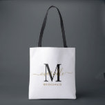 Bridesmaid Gift Gold Black Monogram White Tote Bag<br><div class="desc">This Bridesmaid tote bag features a handwritten gold and black script typography monogram with swashes on a white background. Present your bridesmaids with a tote for carrying items the day of the wedding,  and traditionally presented at the rehearsal dinner or before.</div>