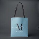 Bridesmaid Gift White Black Monogram Dusty Blue Tote Bag<br><div class="desc">This Bridesmaid tote bag features a handwritten white and black script typography monogram with swashes on a dusty blue background. Present your bridesmaids with a tote for carrying items the day of the wedding,  and traditionally presented at the rehearsal dinner or before.</div>