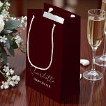 Bridesmaid Minimalist Script | Deep Burgundy Small Gift Bag<br><div class="desc">Give your bridesmaids a personalized touch with our Bridesmaid Minimalist Script Deep Burgundy Small Gift Bag. This elegant bag can be customized with their name,  making it a special gift they'll cherish long after your big day.</div>