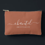 Bridesmaid Modern Script Cosmetic Terracotta Accessory Pouch<br><div class="desc">This Bridesmaid accessory bag features a handwritten white script typography with swashes on a terracotta background. Present your bridesmaids with a toiletry bag for their makeup and small items traditionally presented at the rehearsal dinner,  for use in the early morning before the wedding.</div>