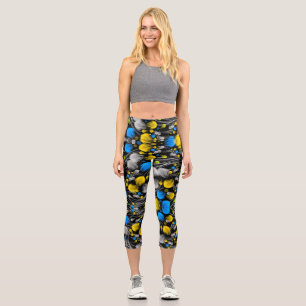 Bright abstract floral pattern on black background capri leggings