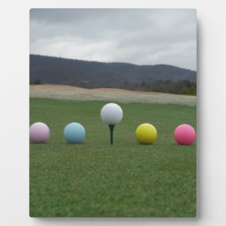 bright coloured Golf Balls on a mountain Plaque