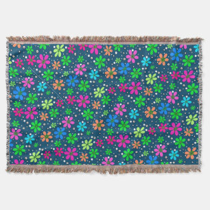 Bright multi-coloured chamomile flowers on a blue throw blanket