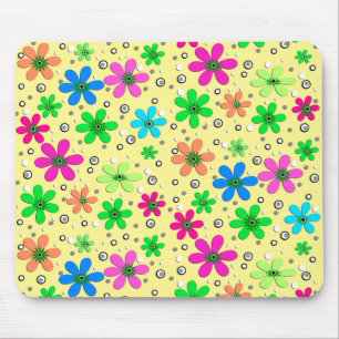 Bright multi-coloured chamomile flowers on a yello mouse pad