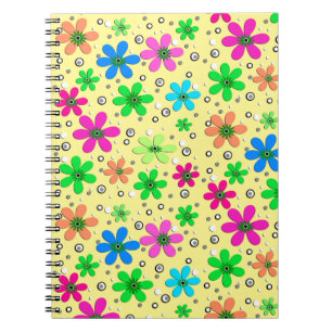 Bright multi-coloured chamomile flowers on a yello notebook
