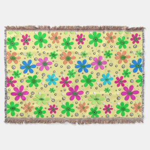 Bright multi-coloured chamomile flowers on a yello throw blanket