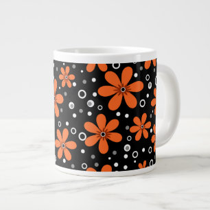 Bright orange flowers on a black background with w large coffee mug