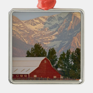 Bright red barn against Mission Mountains in Metal Ornament