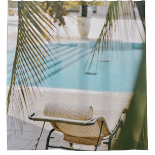 Brown and black armchair beside swimming pool in t