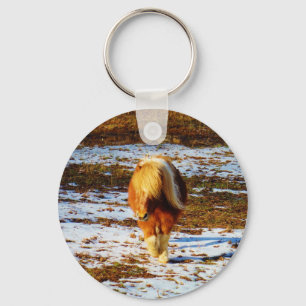 Brown and cream miniature horse in the snow. keychain