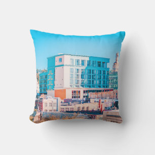 BROWN AND WHITE CONCRETE BUILDING UNDER BLUE SKY THROW PILLOW