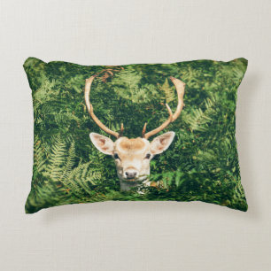 BROWN AND WHITE DEER SURROUNDED BY GREEN PLANTS ACCENT PILLOW