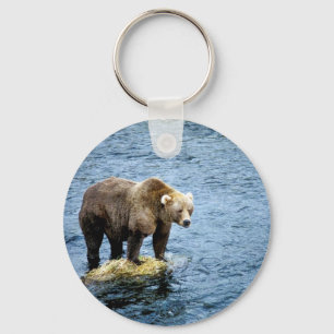 Brown bear on rock in river keychain
