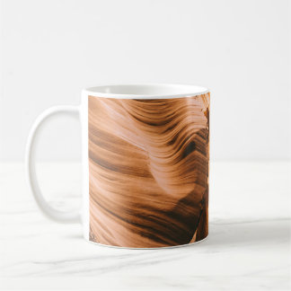 Brown cave under clear sky coffee mug