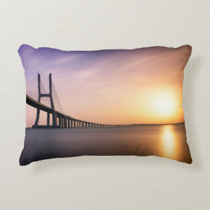 BROWN CONCRETE BRIDGE DURING DAYTIME ACCENT PILLOW