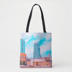 BROWN CONCRETE BUILDING NEAR BARE TREES UNDER BLUE TOTE BAG