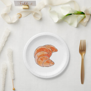 brown croissant bread paper plate