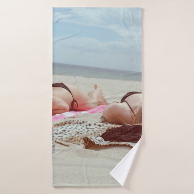 Brown glass bottle across two women bath towel (Bath Towel)