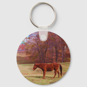 Brown horse in a grass field keychain