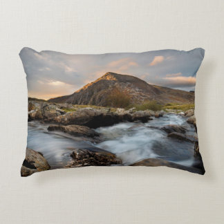 BROWN MOUNTAIN NEAR BODY OF WATER UNDER CLOUDY SKY ACCENT PILLOW