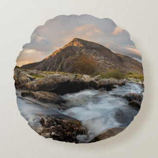 BROWN MOUNTAIN NEAR BODY OF WATER UNDER CLOUDY SKY ROUND PILLOW
