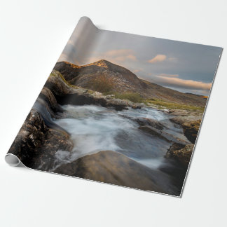 BROWN MOUNTAIN NEAR BODY OF WATER UNDER CLOUDY SKY WRAPPING PAPER
