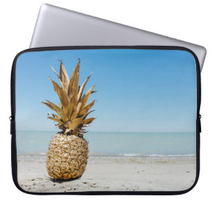 Brown pineapple fruit on seashore laptop sleeve