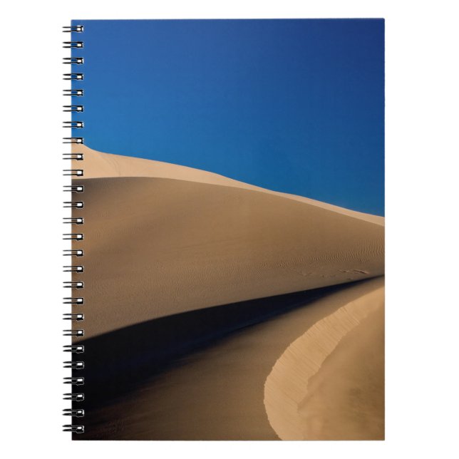 BROWN SAND UNDER BLUE SKY DURING DAYTIME NOTEBOOK (Front)