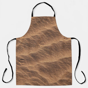 Brown sand with water during daytime apron