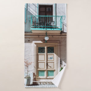 Brown wooden door on white concrete building bath towel