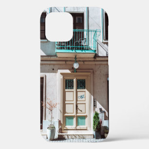 Brown wooden door on white concrete building iPhone 12 case