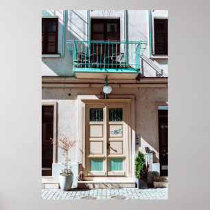 Brown wooden door on white concrete building poster