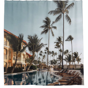 Brown wooden lounge chairs near pool surrounded by