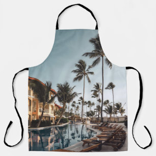 Brown wooden lounge chairs near pool surrounded by apron