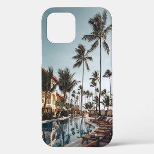 Brown wooden lounge chairs near pool surrounded by iPhone 12 case