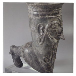 Bucchero vessel in the form of a leg with sculpted tile