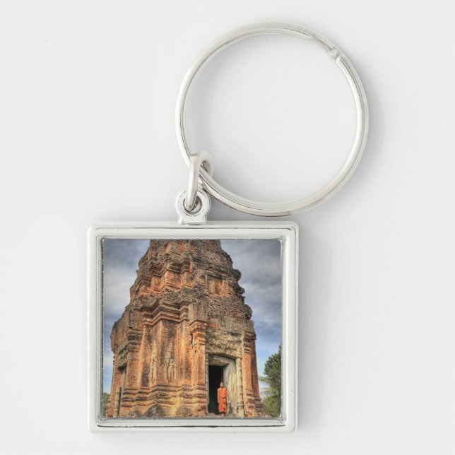 Buddhist monk standing in doorway of temple keychain (Front)