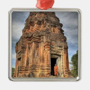 Buddhist monk standing in doorway of temple metal ornament