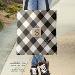 Buffalo Check Plaid Brown Black Monogram Name Tote Bag<br><div class="desc">Black, brown and white buffalo check plaid tote bag personalized with a monogram and optional name shown in a modern, chic handwritten script. The back side is a solid black colour that can be changed as desired. The text font style, size and colour can also be changed for a different...</div>