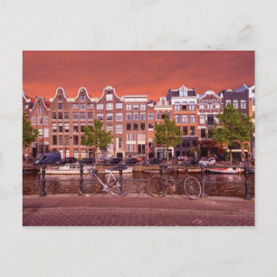 Buildings, canal, bikes in Amsterdam, Netherlands Postcard