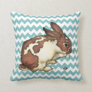 Bunny washing his face with blue chevron throw pillow