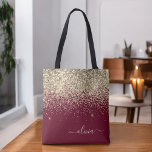 Burgundy Gold Glitter Girly Monogram Glam Tote Bag<br><div class="desc">Gold and Burgundy Faux Sparkle and Glitter Elegant Monogram Book Bag. This Book Bag can be customized to include your initial and first name and given as a gift for Christmas,  Sweet 16 Birthday,  Bridal Shower or a Wedding.</div>